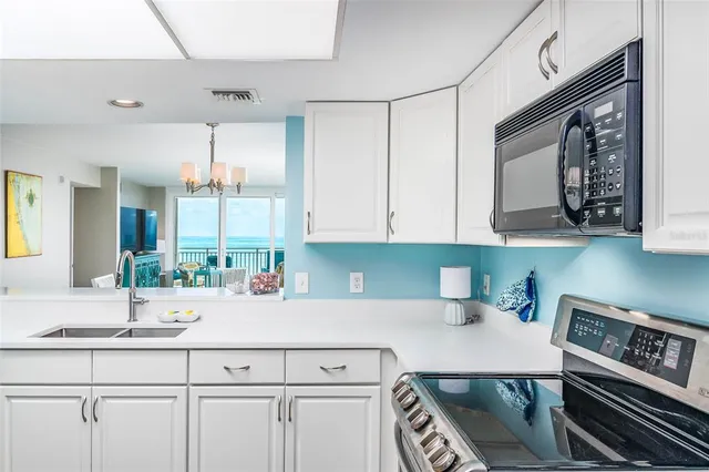 a kitchen with stainless steel appliances a sink a stove and cabinets