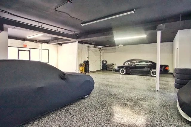 a view of parking garage with cars parked