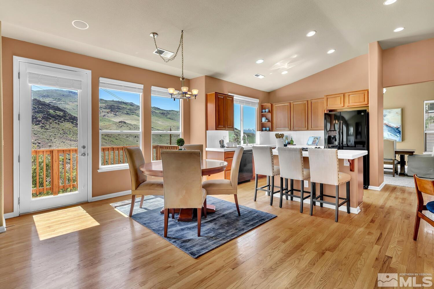 4965 Pinebluff Trail Reno, NV 89519 - Photo 14 of 40 a dining room with wooden floor a chandelier a glass table and chairs
