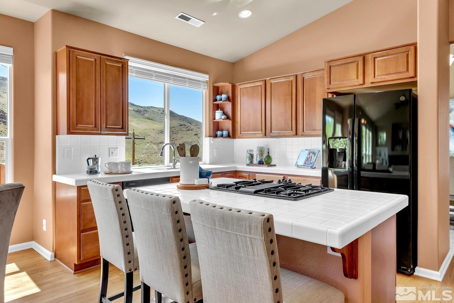 4965 Pinebluff Trail Reno, NV 89519 - Photo 15 of 40 a kitchen with a stove a sink and a refrigerator