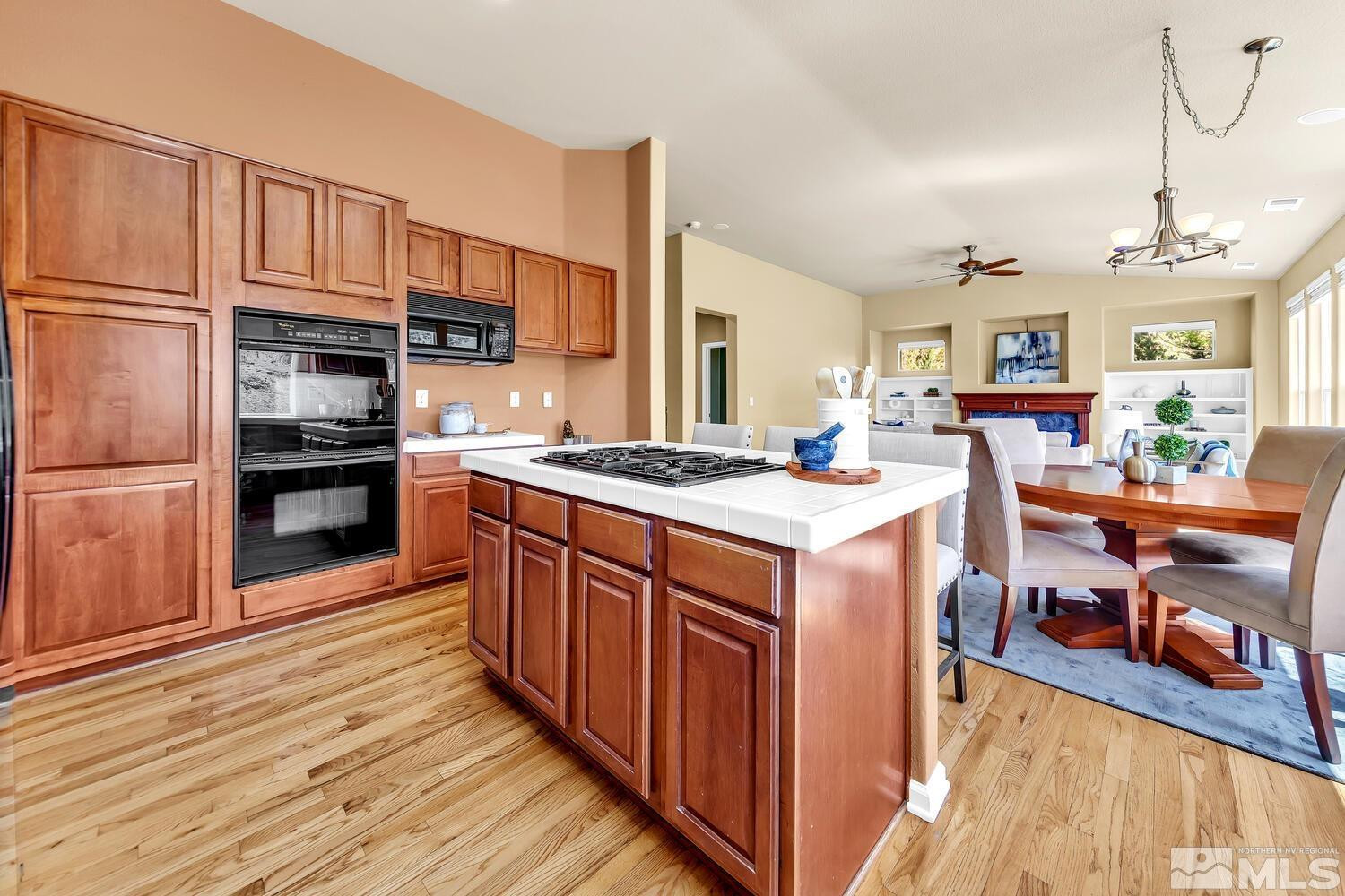 4965 Pinebluff Trail Reno, NV 89519 - Photo 17 of 40 a kitchen with stainless steel appliances granite countertop a stove and a wooden cabinets