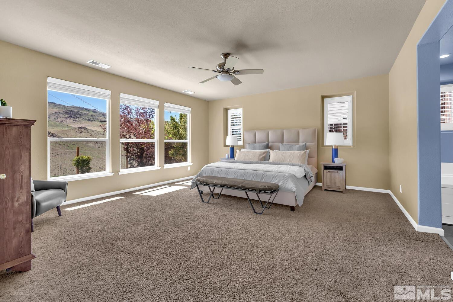 4965 Pinebluff Trail Reno, NV 89519 - Photo 24 of 40 a spacious bedroom with a bed and a large window