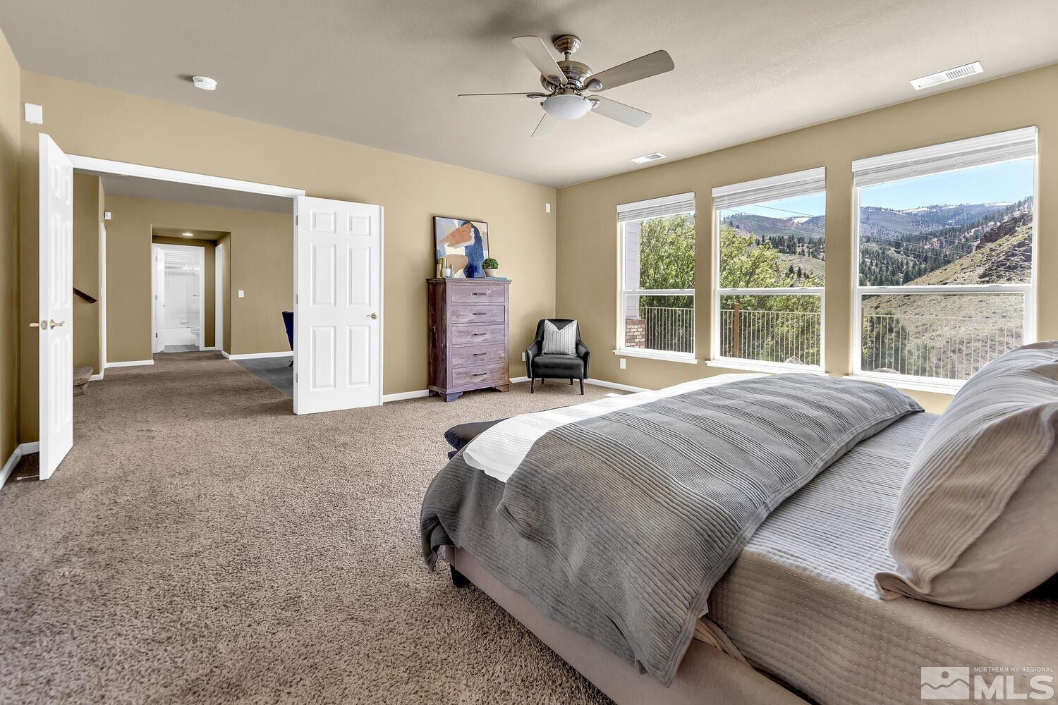 4965 Pinebluff Trail Reno, NV 89519 - Photo 25 of 40 a bedroom with a large bed and a large window