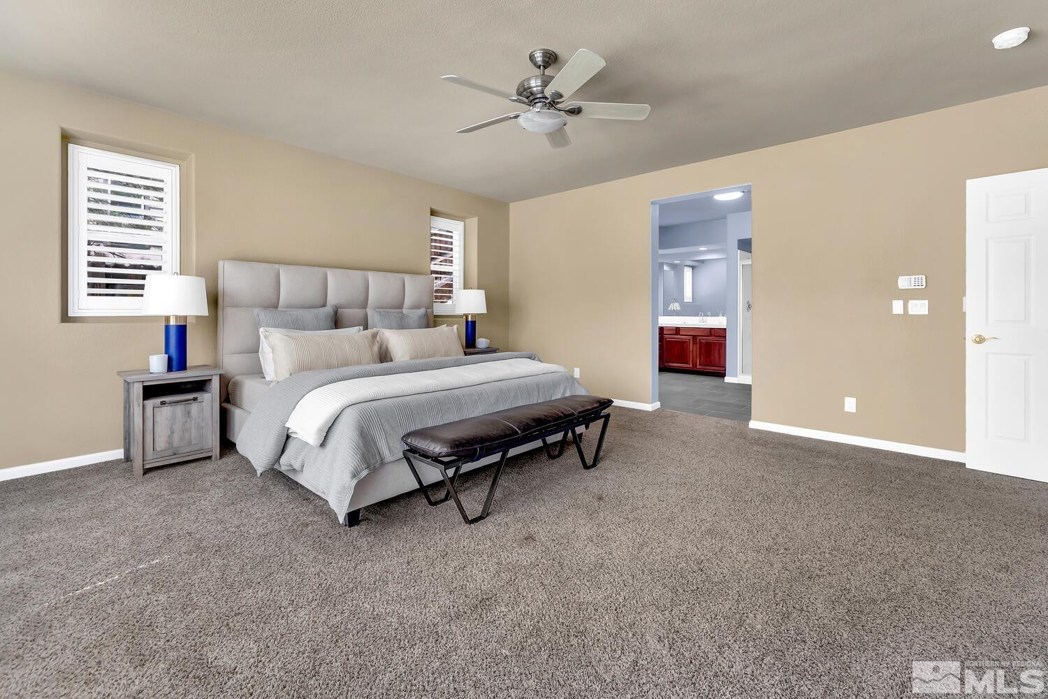 4965 Pinebluff Trail Reno, NV 89519 - Photo 27 of 40 a bedroom with a bed and a chandelier