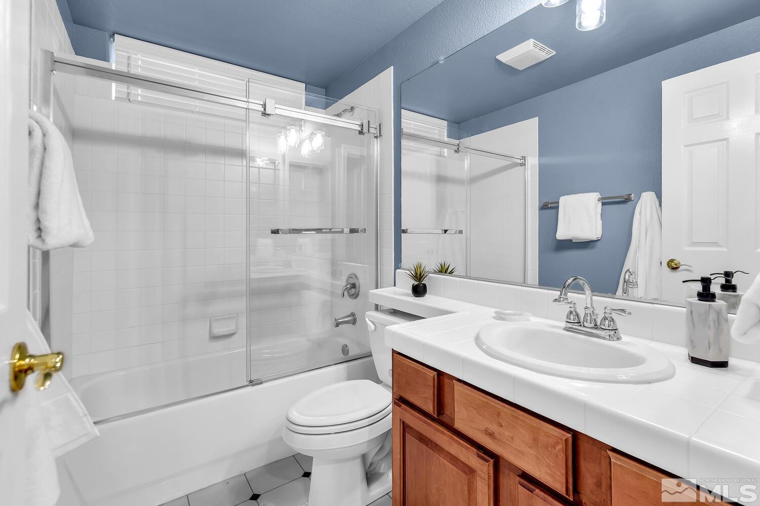 4965 Pinebluff Trail Reno, NV 89519 - Photo 30 of 40 a bathroom with a sink a toilet and shower