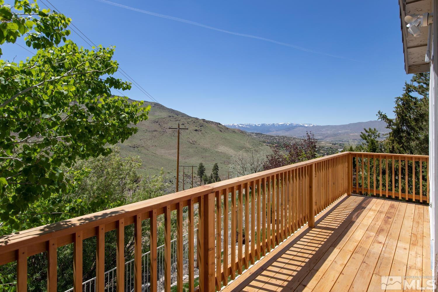4965 Pinebluff Trail Reno, NV 89519 - Photo 36 of 40 a balcony with wooden floor and fence