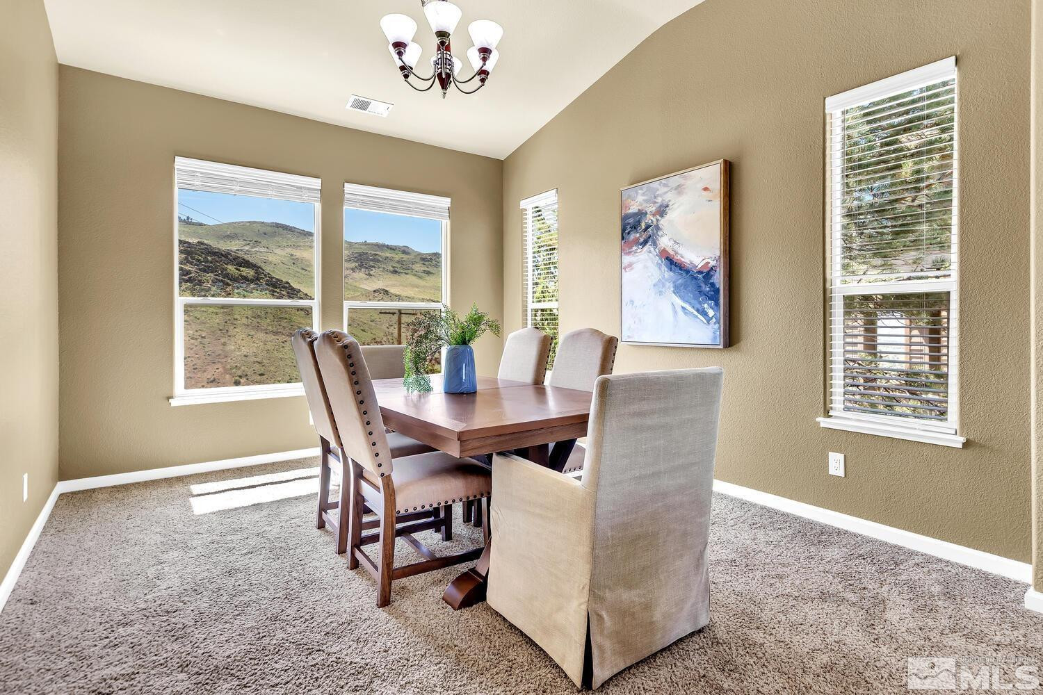 4965 Pinebluff Trail Reno, NV 89519 - Photo 6 of 40 a dining room with furniture a rug and a large window