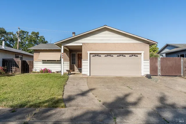 a view of a house with a yard and garage