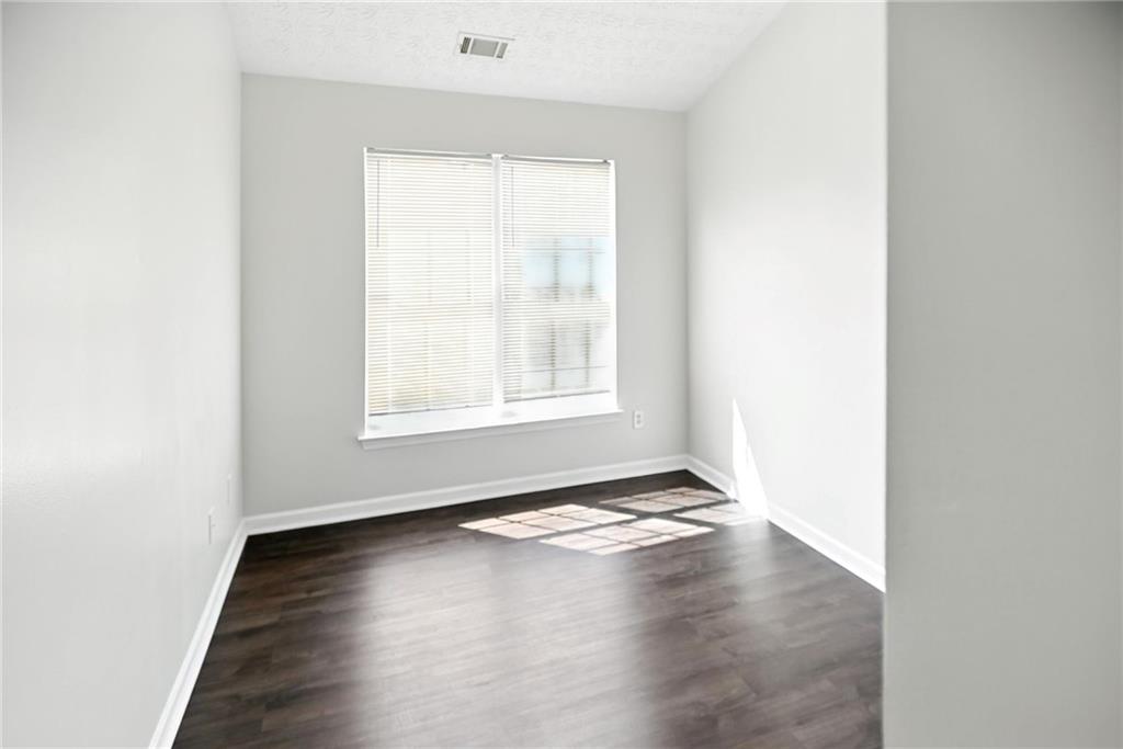 2537 Walden Lake Drive Decatur, GA 30035 - Photo 18 of 22 an empty room with wooden floor and windows