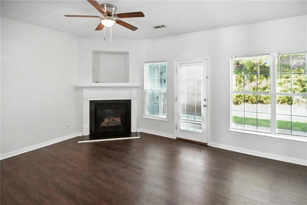 2537 Walden Lake Drive Decatur, GA 30035 - Photo 5 of 22 a view of empty room with wooden floor and fireplace
