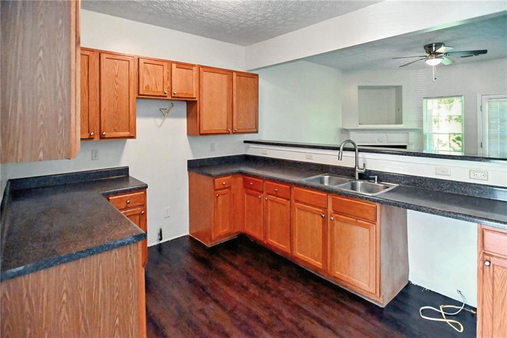 2537 Walden Lake Drive Decatur, GA 30035 - Photo 7 of 22 a kitchen with stainless steel appliances granite countertop a sink a stove and a wooden cabinets