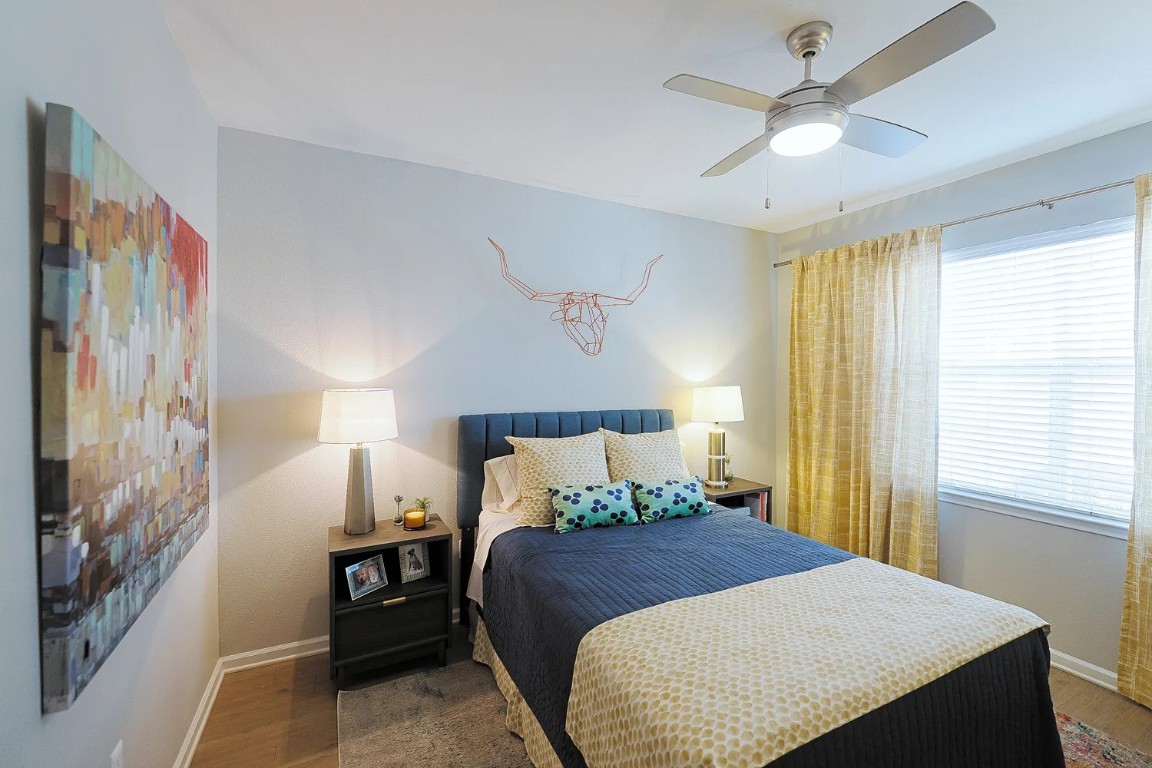 10505 South I-35 Frontage Road, Unit 338 Austin, TX 78747 - Photo 4 of 20 Bedroom with wood finished floors and a ceiling fan