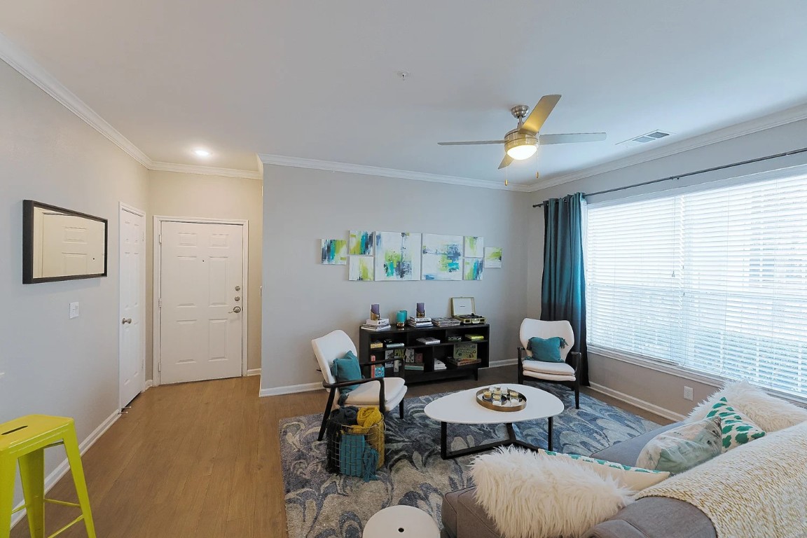 10505 South I-35 Frontage Road, Unit 338 Austin, TX 78747 - Photo 5 of 20 Living area with ornamental molding, wood finished floors, and ceiling fan