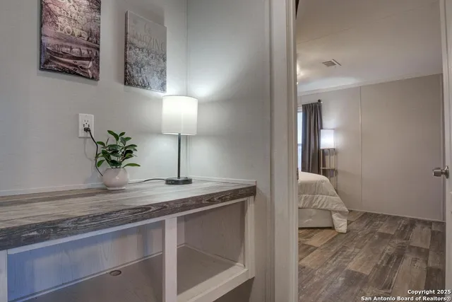 a bedroom with a bed and wooden floor