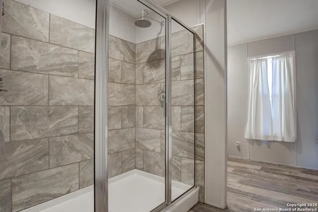 a bathroom with a granite countertop sink and a bathtub