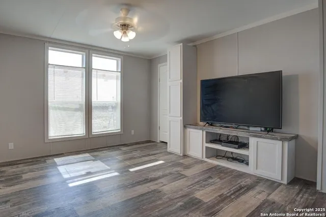 a room with natural light and a flat screen tv