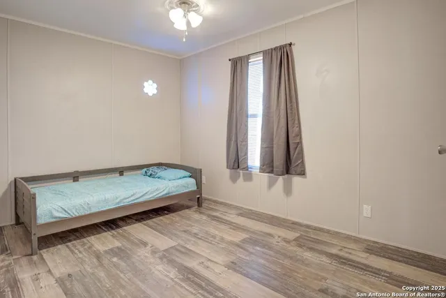 a workspace with wooden floor and windows