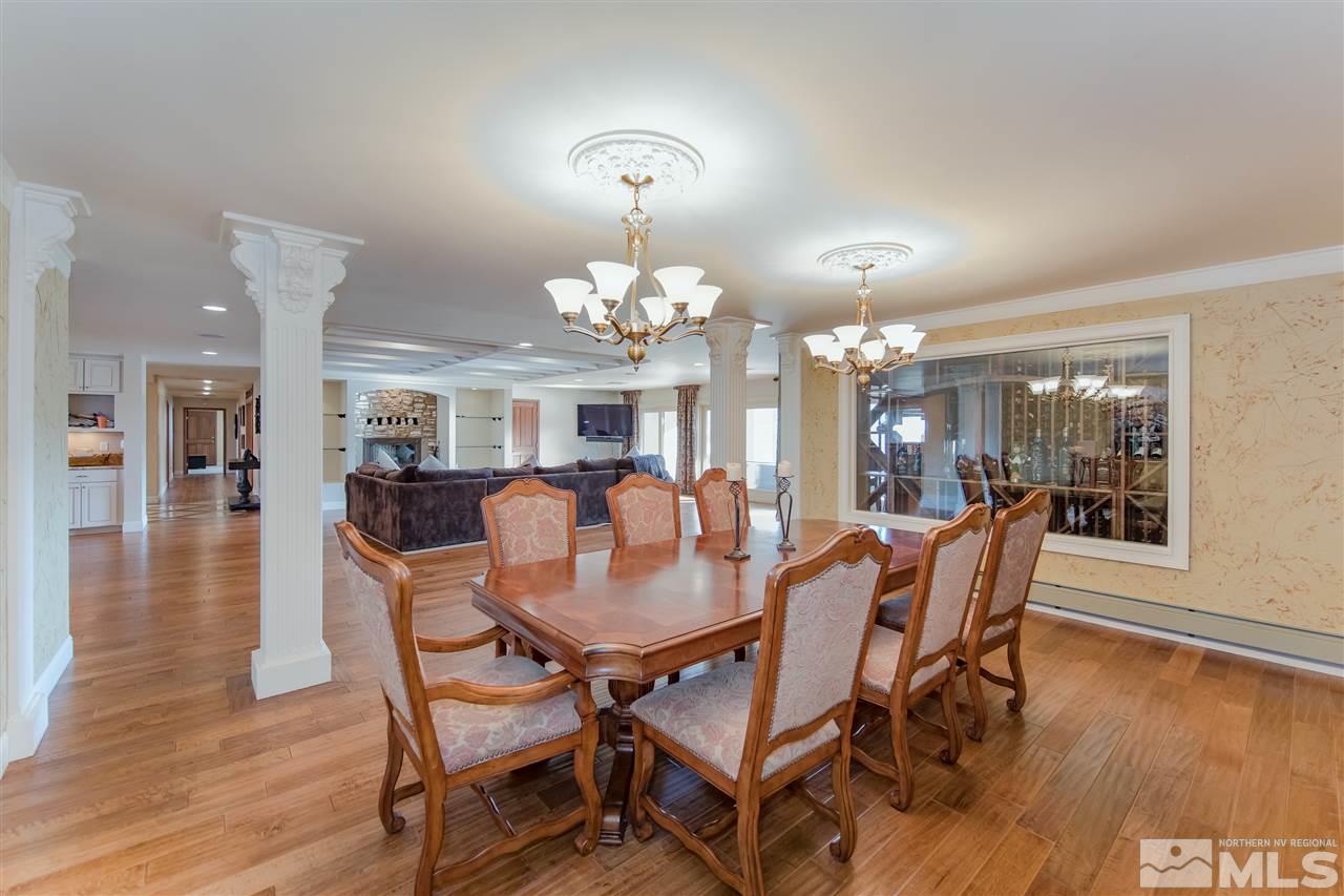 3520 Frost Lane Reno, NV 89511 - Photo 7 of 24 a dining room with wooden floor a chandelier a wooden table and chairs