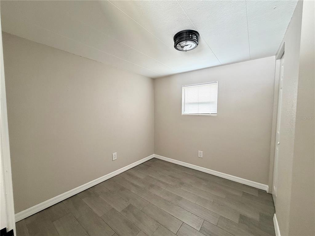 7037 Lofty Drive Port Richey, FL 34668 - Photo 6 of 9 an empty room with a window