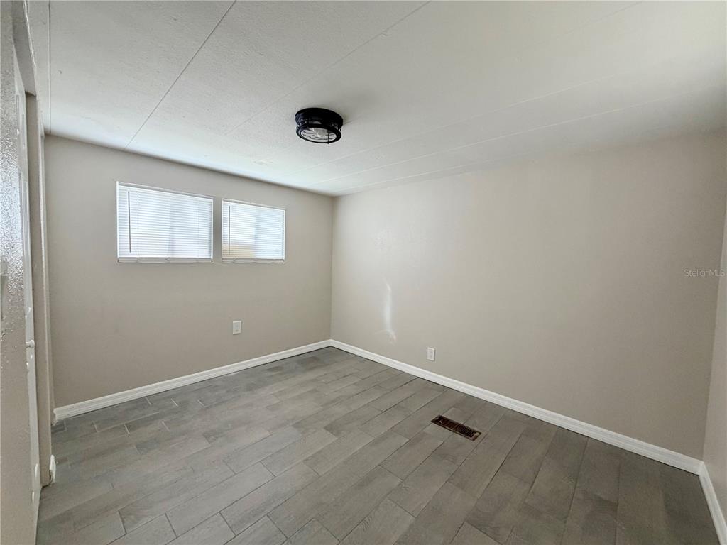 7037 Lofty Drive Port Richey, FL 34668 - Photo 9 of 9 an empty room with windows