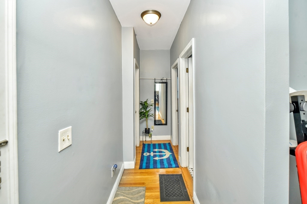5-7 Everett Avenue, Unit 52 Boston, MA 02125 - Photo 5 of 12 hallway view with wooden floor and bathroom