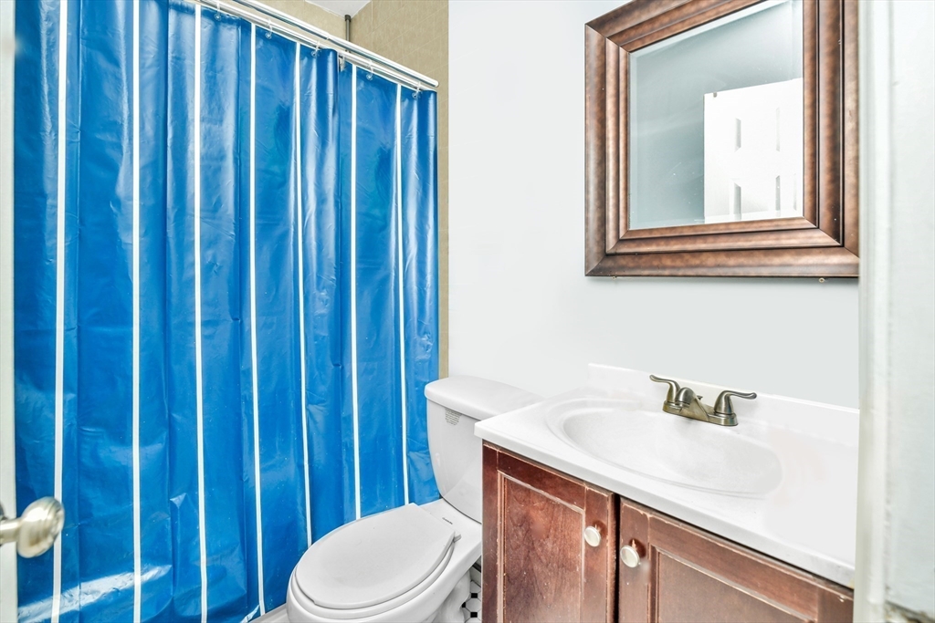 5-7 Everett Avenue, Unit 52 Boston, MA 02125 - Photo 7 of 12 a bathroom with a sink a toilet and shower