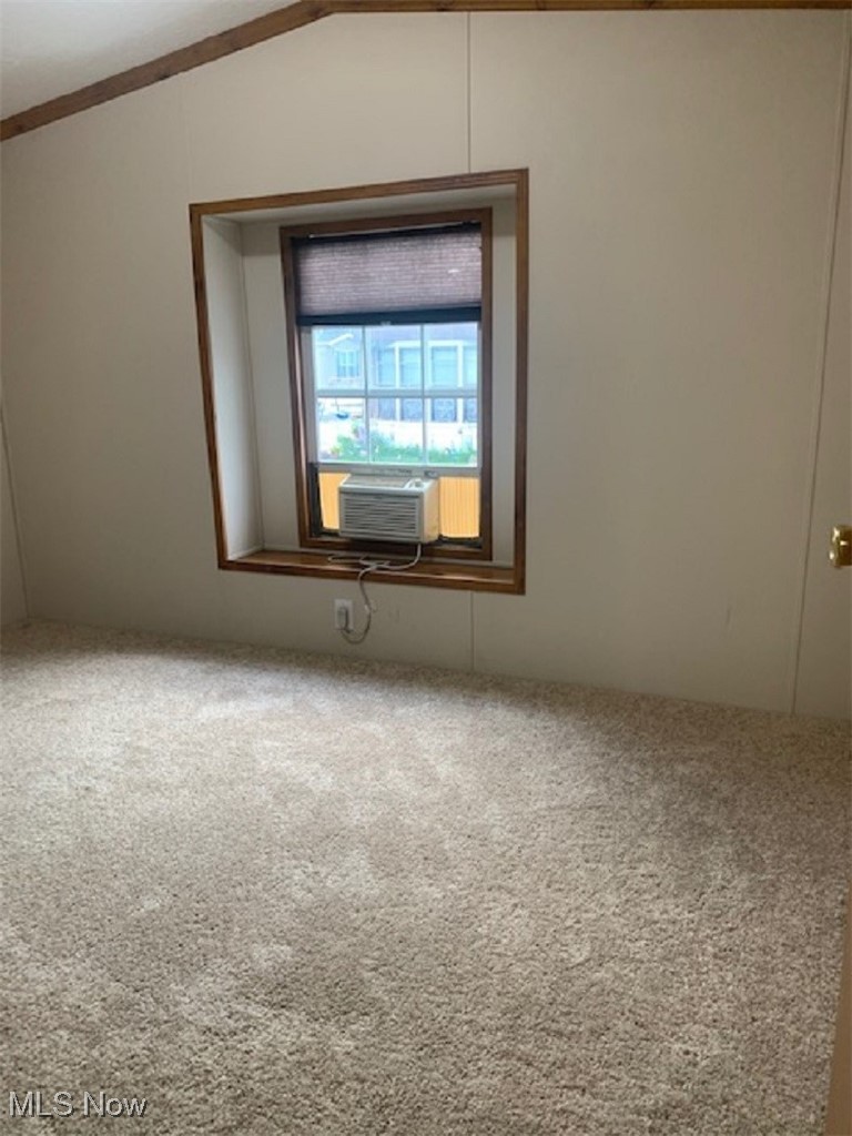 27216 Cook Road, Unit 24 Olmsted Falls, OH 44138 - Photo 19 of 23 Spare room with cooling unit, vaulted ceiling, and carpet