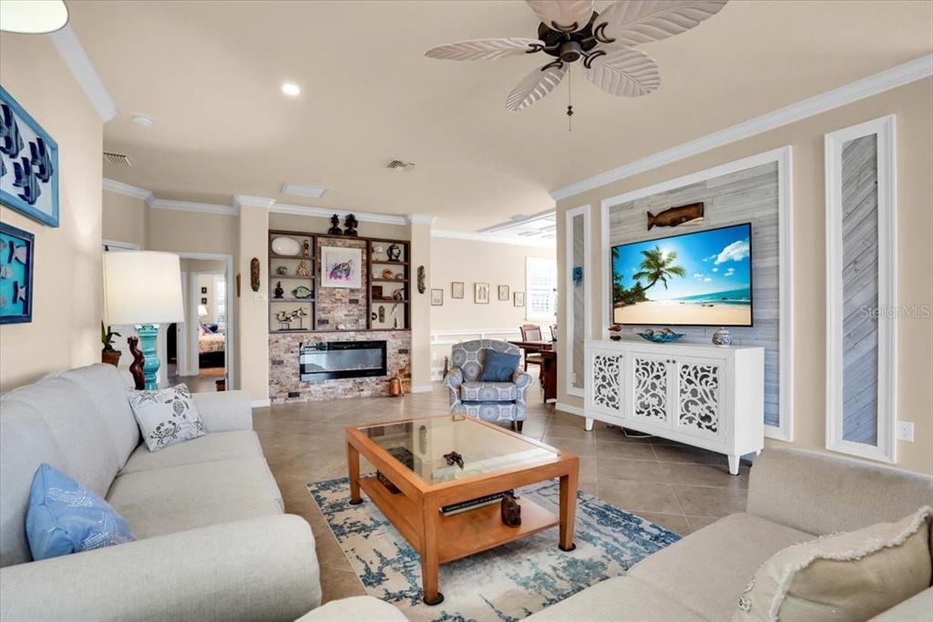 20201 Ragazza Circle, Unit 201 Venice, FL 34293 - Photo 15 of 58 a living room with furniture and a flat screen tv