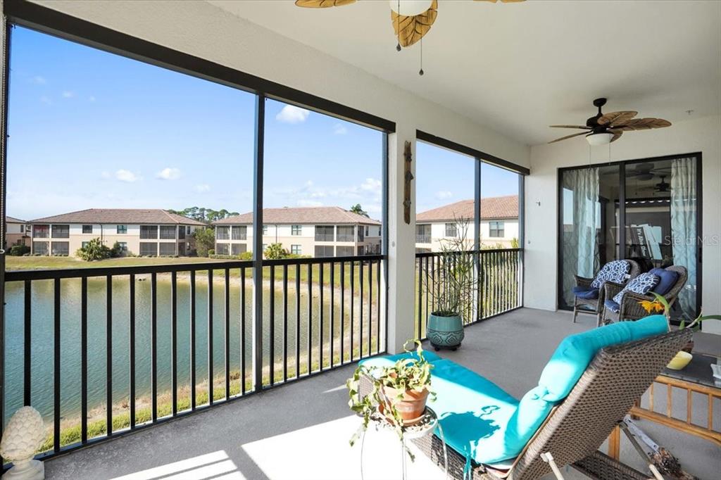 20201 Ragazza Circle, Unit 201 Venice, FL 34293 - Photo 27 of 58 a living room with furniture and floor to ceiling windows
