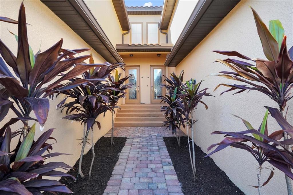 20201 Ragazza Circle, Unit 201 Venice, FL 34293 - Photo 3 of 58 a view of entryway with wooden stairs