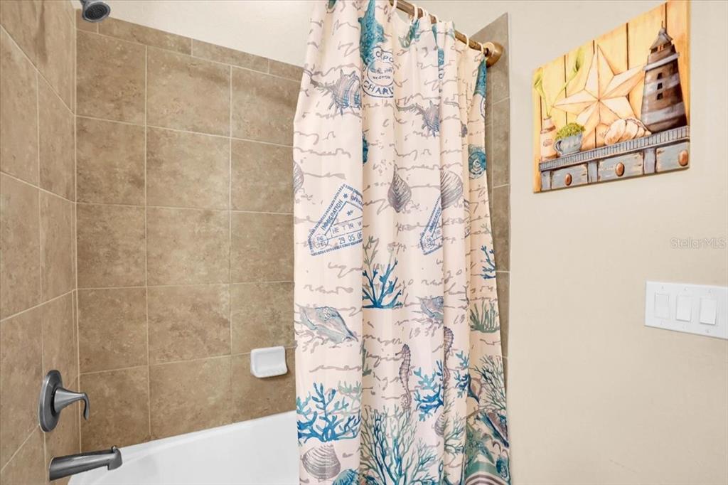 20201 Ragazza Circle, Unit 201 Venice, FL 34293 - Photo 37 of 58 a bathroom with a shower curtain