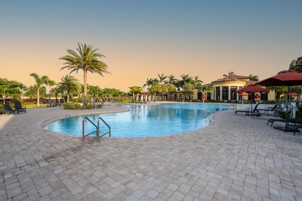 20201 Ragazza Circle, Unit 201 Venice, FL 34293 - Photo 45 of 58 a view of a swimming pool and lounge chairs
