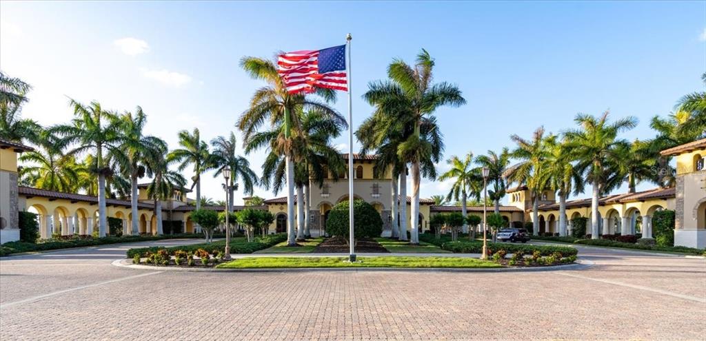 20201 Ragazza Circle, Unit 201 Venice, FL 34293 - Photo 7 of 58 a palm tree sitting in front of a house with a yard