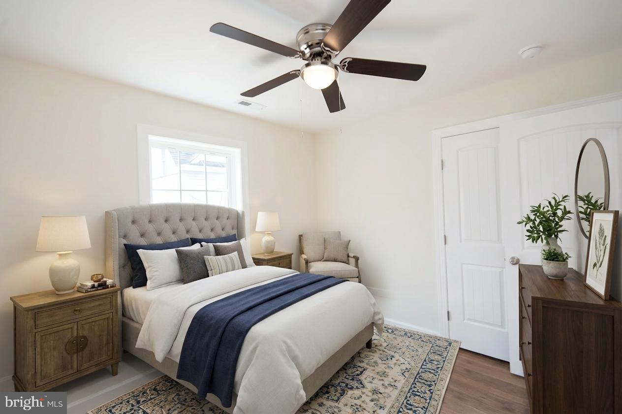 406 Charles Street Hurlock, MD 21643 - Photo 14 of 17 a bedroom with a bed and a potted plant