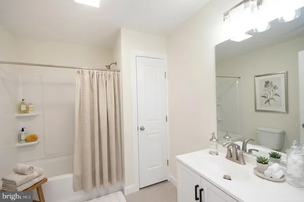 a bathroom with a sink a mirror and a shower