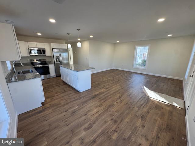 406 Charles Street Hurlock, MD 21643 - Photo 3 of 8 a living room with hard wood floors and a kitchen