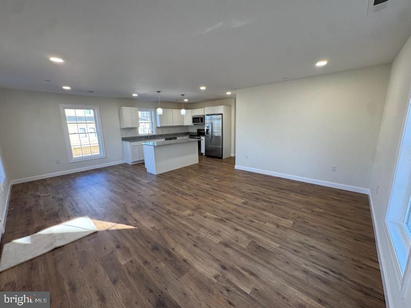406 Charles Street Hurlock, MD 21643 - Photo 4 of 8 a open kitchen with white cabinets and wooden floor