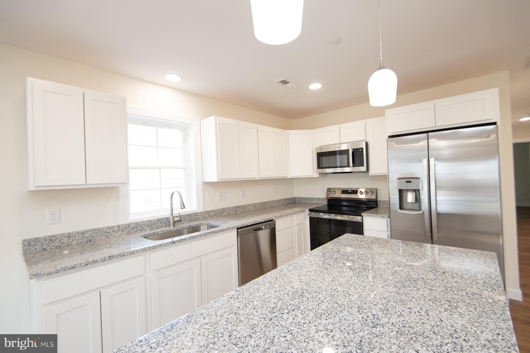 406 Charles Street Hurlock, MD 21643 - Photo 6 of 17 a kitchen with a sink stainless steel appliances and window