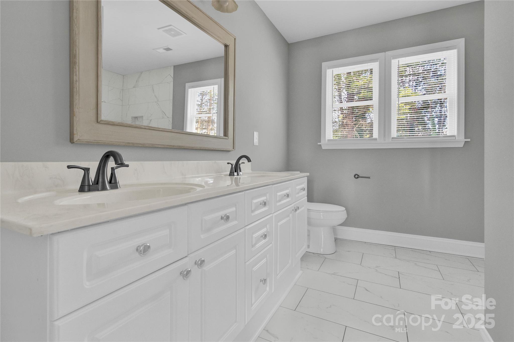2848 Ridge Crossing Court Northwest Concord, NC 28027 - Photo 15 of 37 a bathroom with a double vanity sink toilet and a mirror
