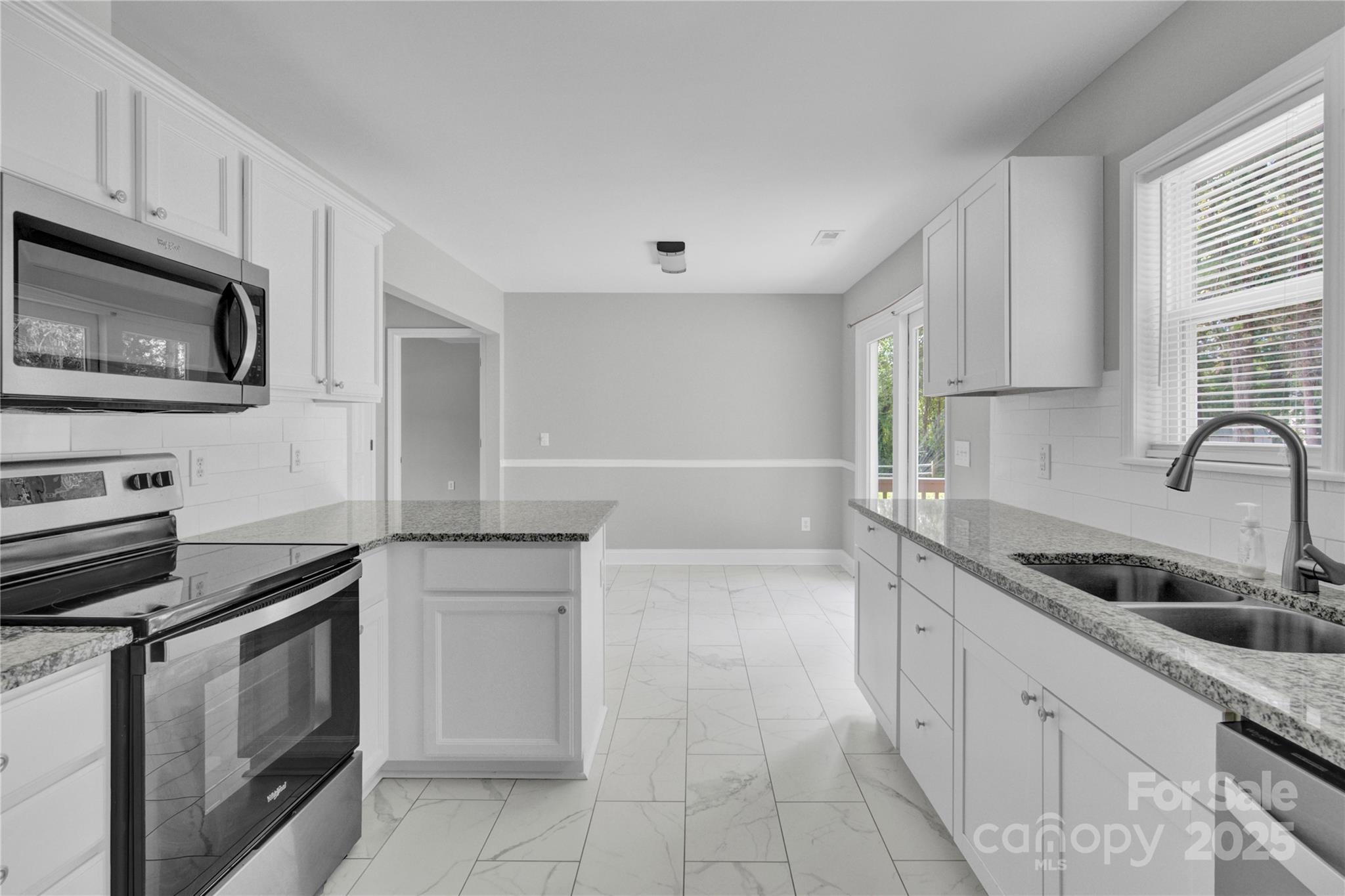2848 Ridge Crossing Court Northwest Concord, NC 28027 - Photo 26 of 37 a kitchen with granite countertop a sink dishwasher stove and cabinets