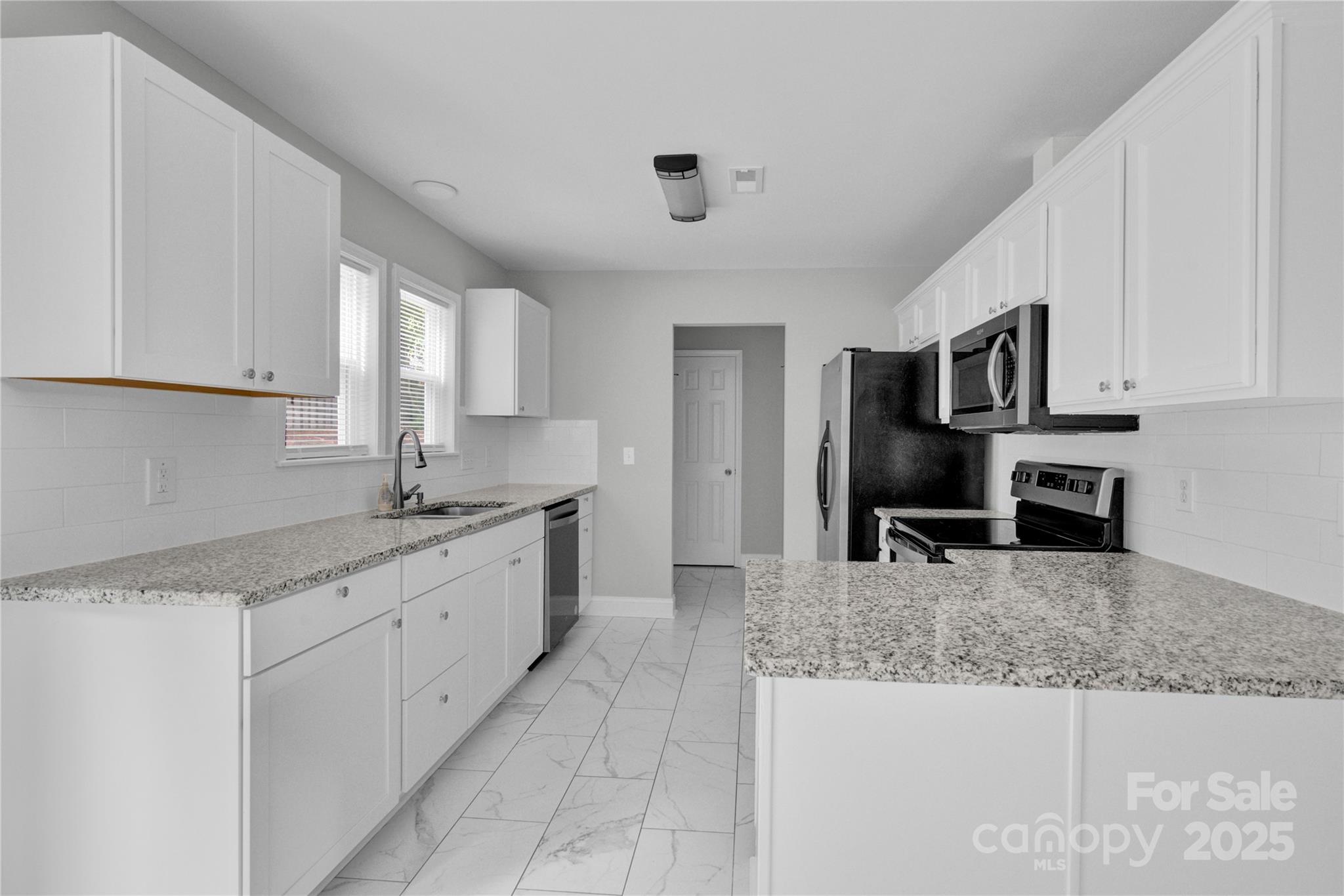 2848 Ridge Crossing Court Northwest Concord, NC 28027 - Photo 27 of 37 a kitchen with stainless steel appliances granite countertop a sink stove and cabinets