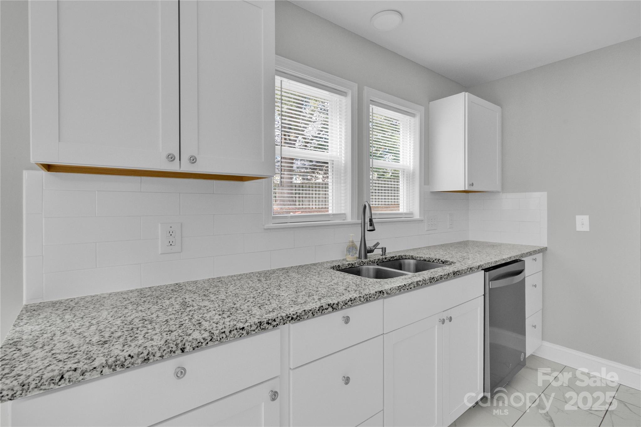 2848 Ridge Crossing Court Northwest Concord, NC 28027 - Photo 29 of 37 a kitchen with granite countertop cabinets sink and window
