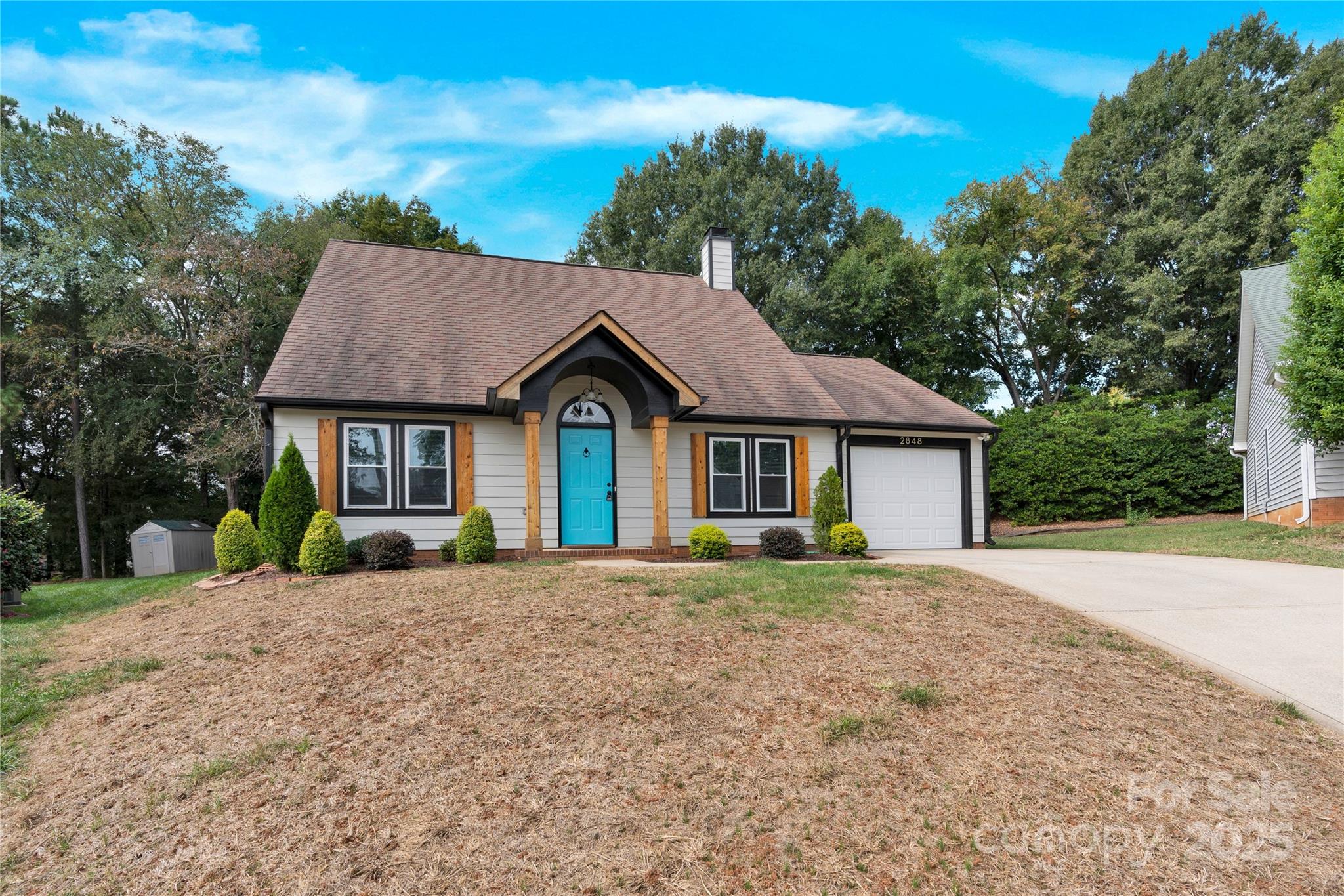 2848 Ridge Crossing Court Northwest Concord, NC 28027 - Photo 8 of 37 a front view of a house with a yard and trees