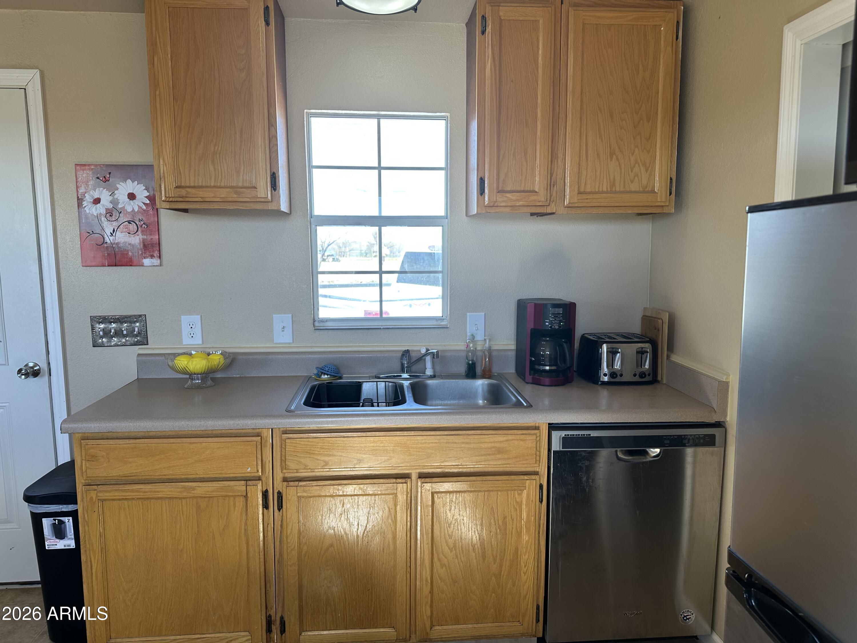5778 South Kino Road Hereford, AZ 85615 - Photo 11 of 18 a kitchen with stainless steel appliances granite countertop a sink stove and refrigerator