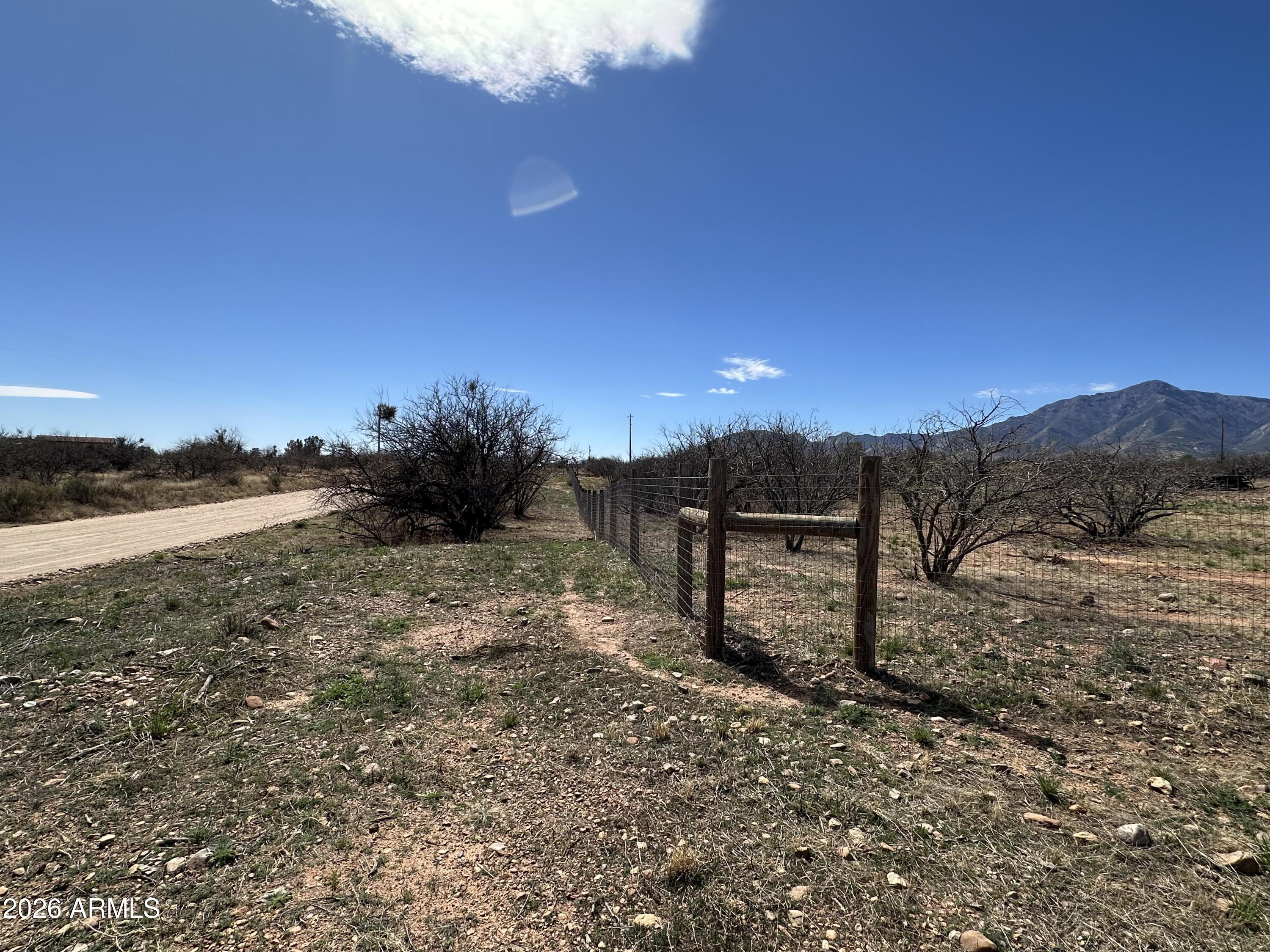 5778 South Kino Road Hereford, AZ 85615 - Photo 12 of 18 a view of a dry yard with wooden fence