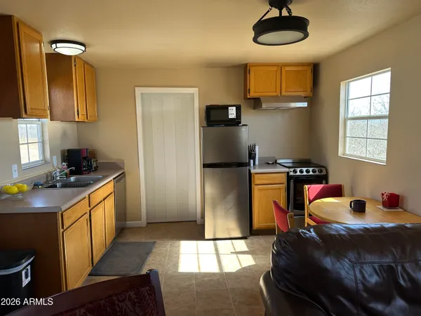a kitchen with stainless steel appliances granite countertop a sink a stove and refrigerator
