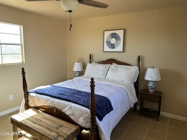 a bed sitting in a bedroom next to a window
