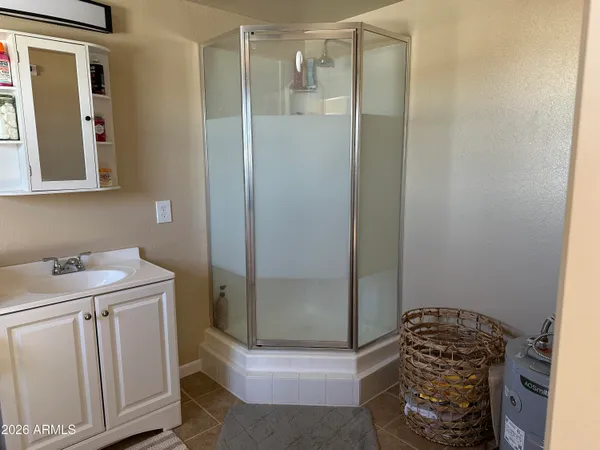 a bathroom with a granite countertop sink a toilet and shower