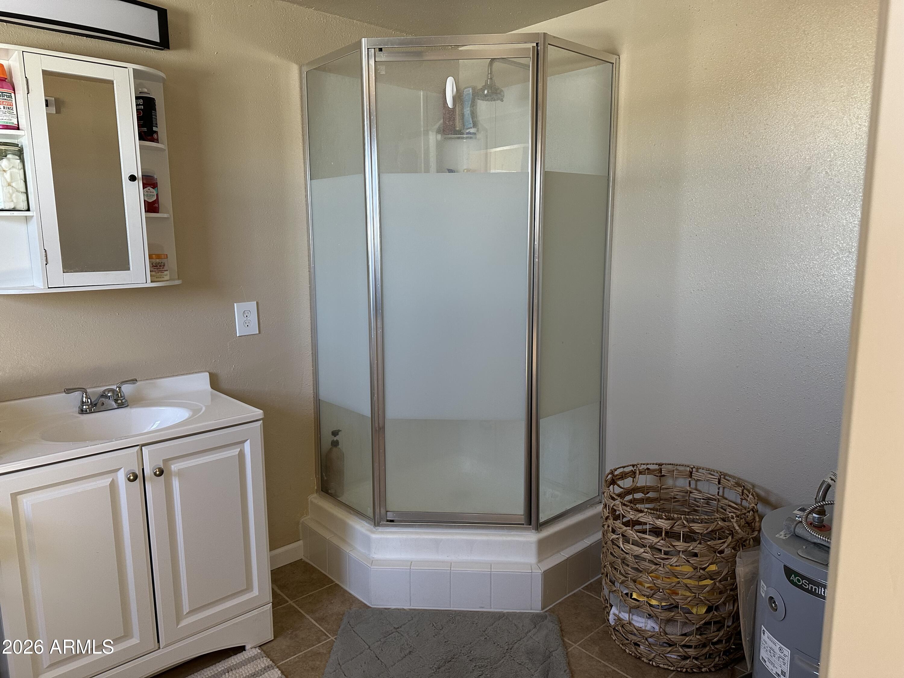 5778 South Kino Road Hereford, AZ 85615 - Photo 7 of 18 a bathroom with a granite countertop sink a toilet and shower
