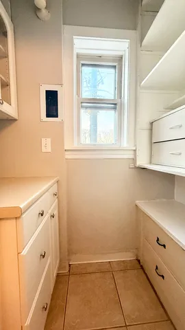 a view of kitchen with white cabinets
